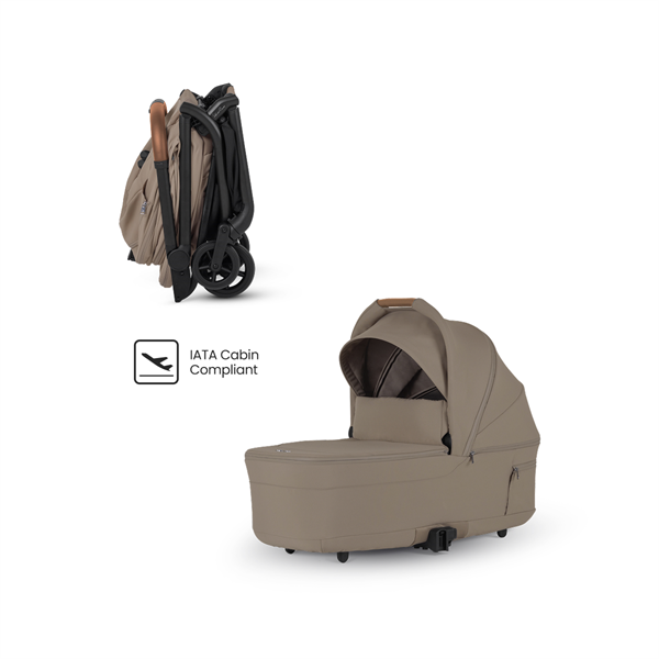Beige baby stroller with IATA Cabin Compliant label on a white background