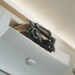 Foldable bicycle stored inside a white cabinet with a neutral background