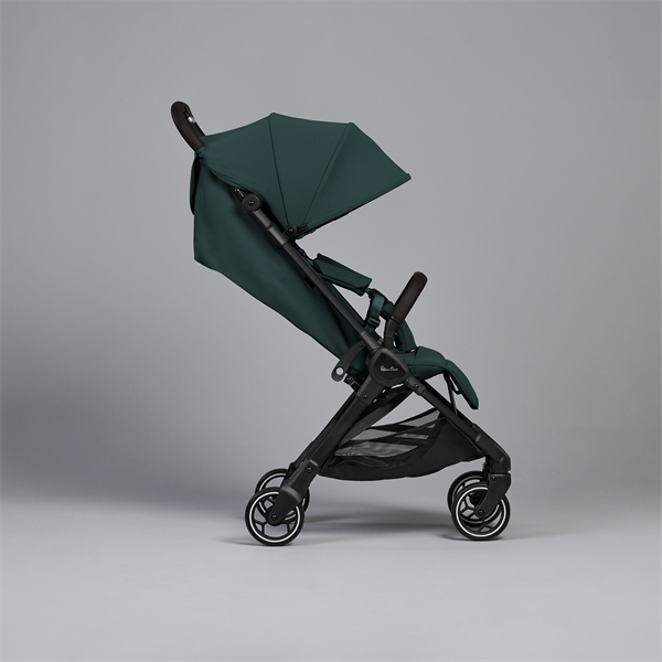 Green stroller on a gray background
