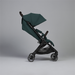 Green stroller on a gray background
