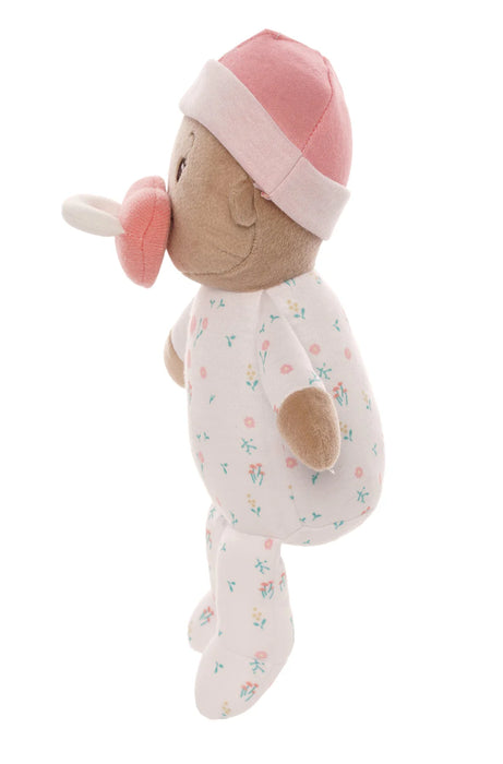 Stuffed toy resembling a baby with a pink hat and pacifier on a white background