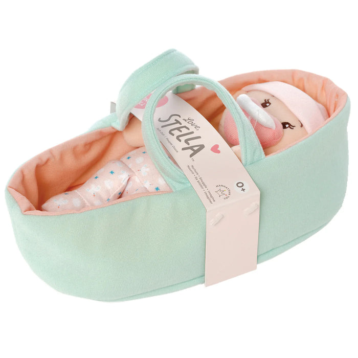 Mint green baby carrier with pink interior containing a baby doll, branded 'Love, Stella'.