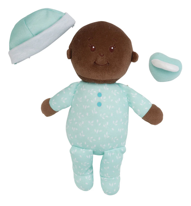 Baby doll with brown skin, wearing a light blue outfit with white polka dots, hat, and pacifier on a white background.