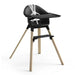 Black high chair with wooden legs on a white background