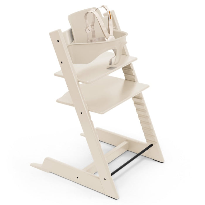 Stokke Tripp Trapp wooden high chair in Vanilla with tray and cushion on a white background