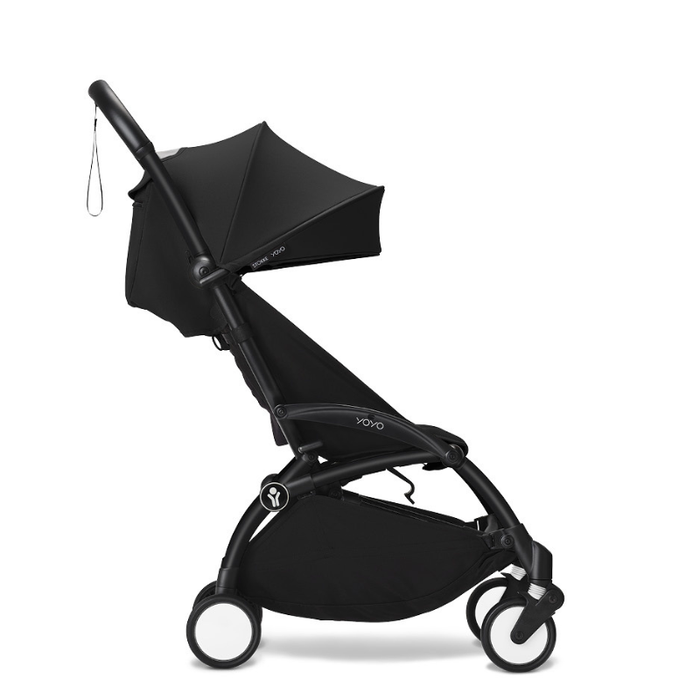 Black travel stroller on a white background