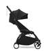 Black travel stroller on a white background