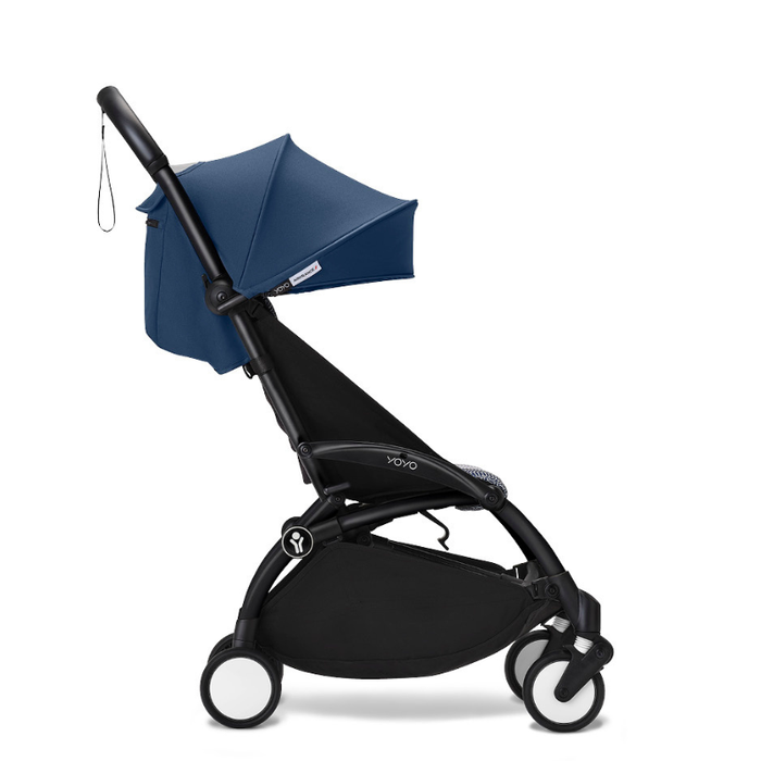 Black and navy blue travel stroller on a white background