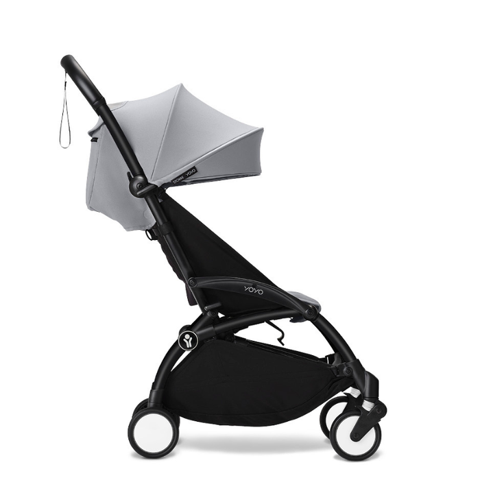 Black and grey travel stroller on a white background