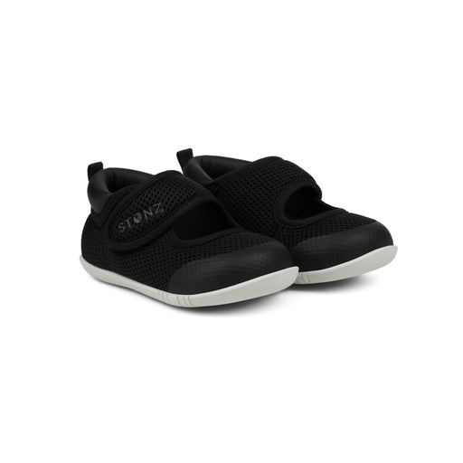 Pair of black children's shoes with velcro straps on a white background