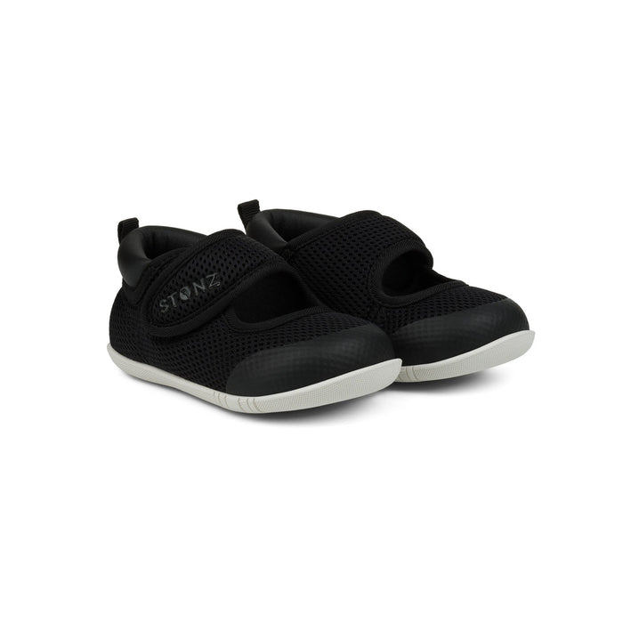 Pair of black children's shoes with velcro straps on a white background