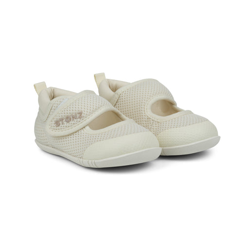 Pair of white baby shoes with velcro straps on a white background