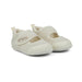 Pair of white baby shoes with velcro straps on a white background