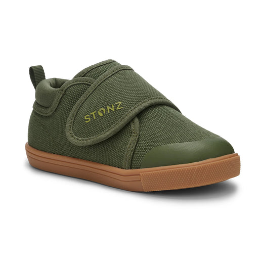 Green children's shoe with brown rubber sole on a white background