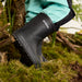 Black rain boot with 'STONZ' branding on a natural background