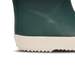 Close-up of a green rain boot with a white sole on a white background