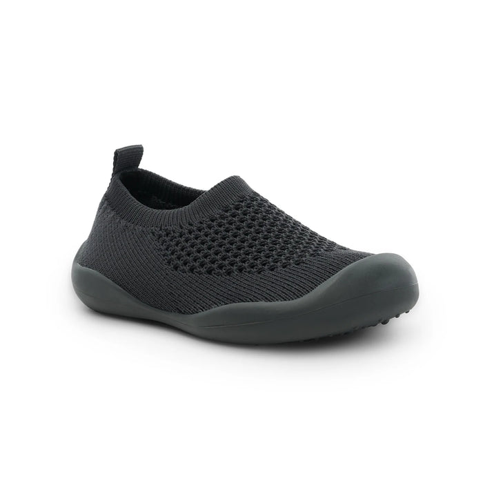 Black slip-on shoe on a white background