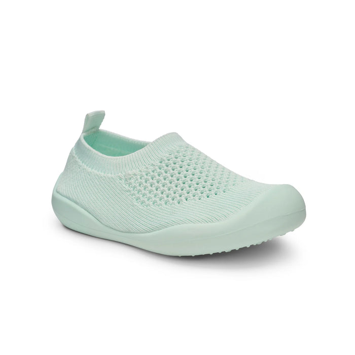 Mint green slip-on shoe on a white background