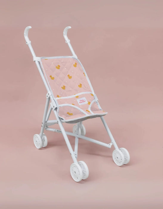 White baby stroller with pink canopy and duck pattern on a pink background