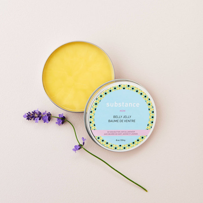 Yellow belly jelly in a tin with a decorative lid on a light pink background