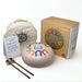 Tangram drum with carrying bag, drumsticks, and packaging on a white background