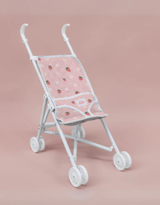White baby doll stroller with pink canopy featuring strawberry pattern on a pink background