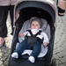 Baby in a Thule stroller in a cobblestone setting