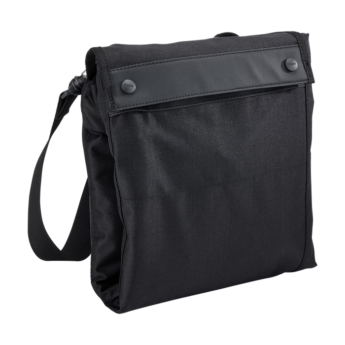 Black travel stroller bag folded up small on a white background