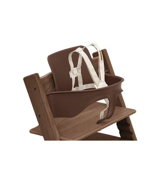 Wooden high chair with brown harness and white straps