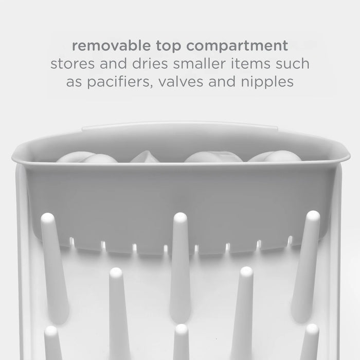 White bottle drying rack with hooks for storing smaller items on a light gray background