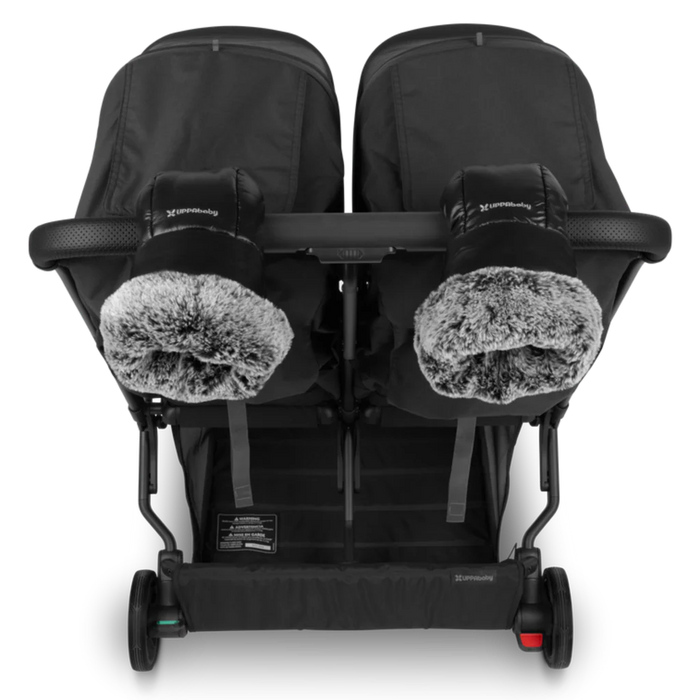 Black double stroller shown with stroller mittens attached on a white background
