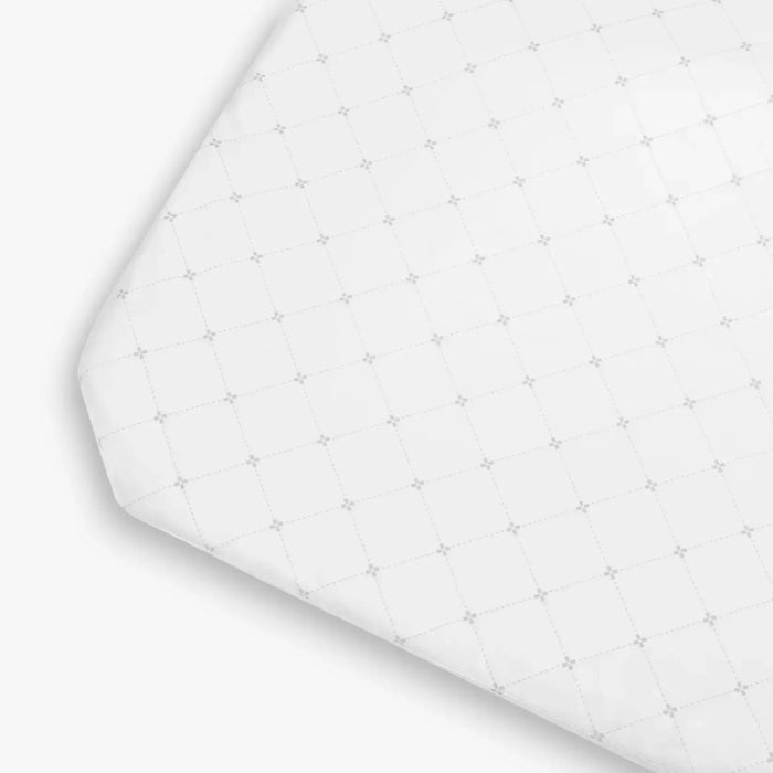 White fitted sheet with subtle pattern on a white background