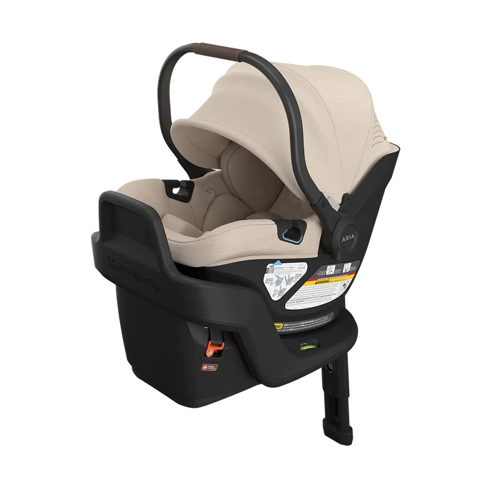 Beige UPPAbaby Aria V2 infant car seat with beige canopy and black base on a white background