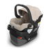 Baby car seat with beige interior and black exterior on a white background