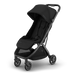 A black UPPAbaby stroller with a dark gray frame, shown at a three-quarter angle on a clean white background. The stroller features a large canopy, padded seat, footrest, and storage basket.
