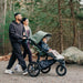Family walking with a stroller in a forest setting