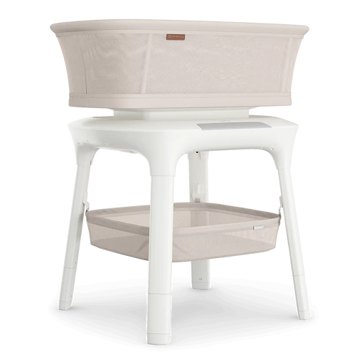 White bassinet with beige fabric on a white background