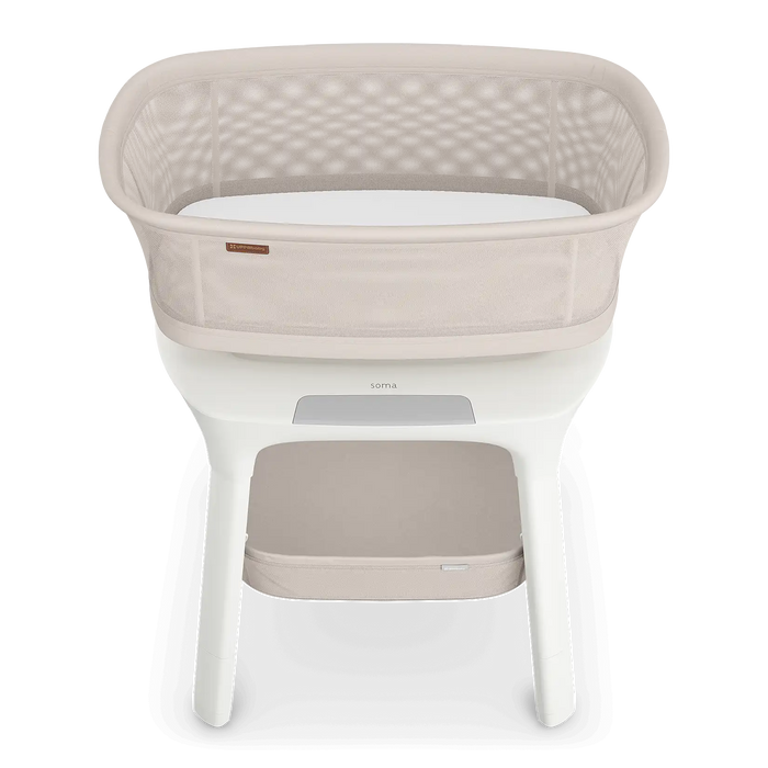 Baby bassinet with white mattress and beige cover on a white background