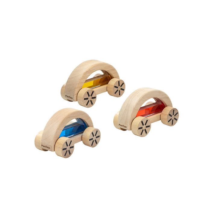 Three wooden toy cars with colorful interiors on a white background