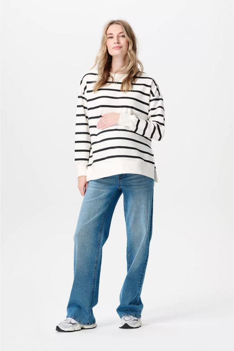 Woman wearing a black and white striped shirt and blue jeans on a white background