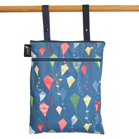 caption-Zippered Wet Bag with hanging straps and colourful kites on a navy backdrop
