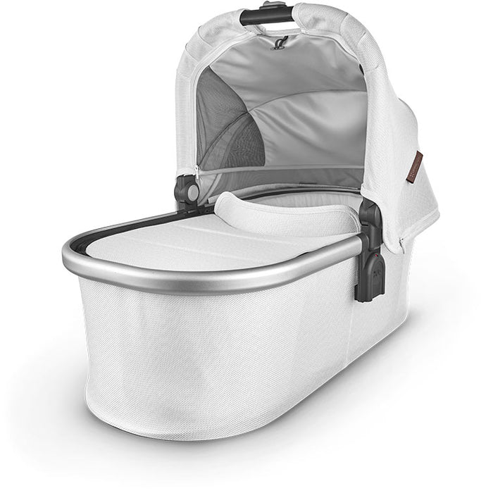 caption-Bryce Uppababy bassinet for stroller use in creamy white chenille fabric on canopy and body of bassinet plus zippered overlay. Silver metal framing to coordinate with stroller frame is exposed at upper part of bassinet