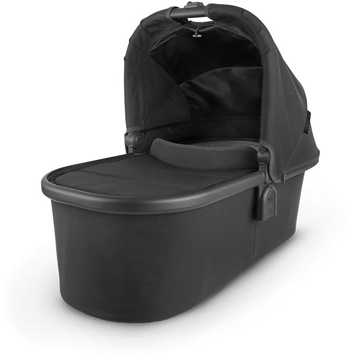 caption-Jake Uppababy bassinet for stroller use in dark black fabric on canopy and body of bassinet plus zippered overlay. Black metal framing to coordinate with stroller frame is exposed at upper part of bassinet