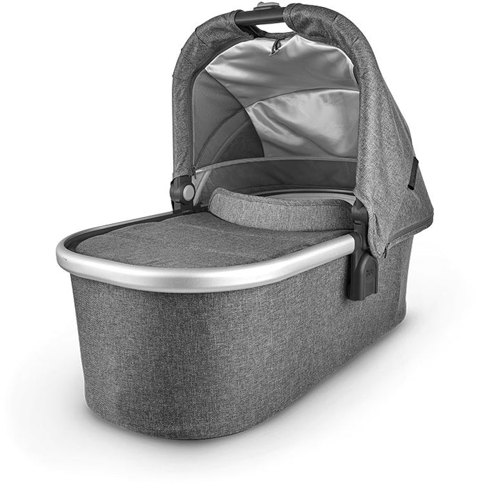 caption-Jordan Uppababy bassinet for stroller use in dark grey melanged fabric on canopy and body of bassinet plus zippered overlay. Silver metal framing to coordinate with stroller frame is exposed at upper part of bassinet