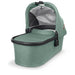 cation-Gwen Uppababy bassinet for stroller use in deep green melange fabric on canopy and body of bassinet plus zippered overlay. Black carbon metal framing to coordinate with stroller frame is exposed at upper part of bassinet