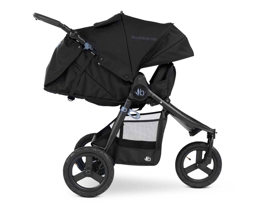 Fully reclined 3 wheeled bumbleride stroller with black frame and black coloured canopy and seat. The leg rest is adjusted upward to enclose the look and feel of a bassinet. 