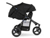 Fully reclined 3 wheeled bumbleride stroller with black frame and black coloured canopy and seat. The leg rest is adjusted upward to enclose the look and feel of a bassinet. 