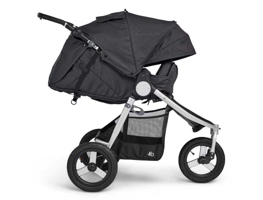 Fully reclined 3 wheeled Bumbleride stroller with silver frame and dark charcoal coloured canopy and seat in Dusk. The leg rest is adjusted upward to enclose the look and feel of a bassinet. 