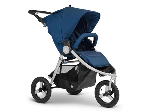 3 wheeled Bumbleride brand stroller with silver frame. Seat is in upright position with canopy extended in navy toned colour called Maritime Blue. A padded bumper bar arches over the toddler seat in the same colour fabric.