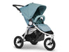 3 wheeled Bumbleride brand stroller with silver frame. Seat is in upright position with canopy extended in pastel aqua green toned colour called Seaglass. A padded bumper bar arches over the toddler seat in the same colour fabric.